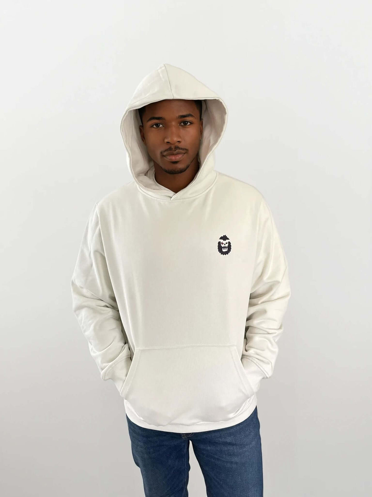 Man wearing a white hoodie with a Bigfoot 2099 design on the chest, showcasing a modern and stylish look.